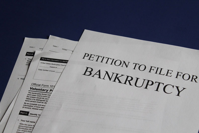 A piece of paper that represents a petition to file for bankruptcy.