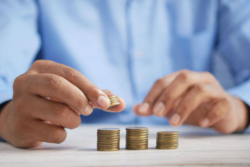 A man putting money aside for a rainy day fund.