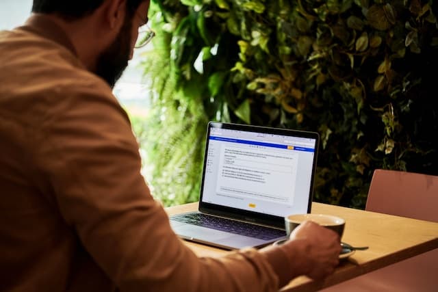 Person using a laptop in a coffee shop